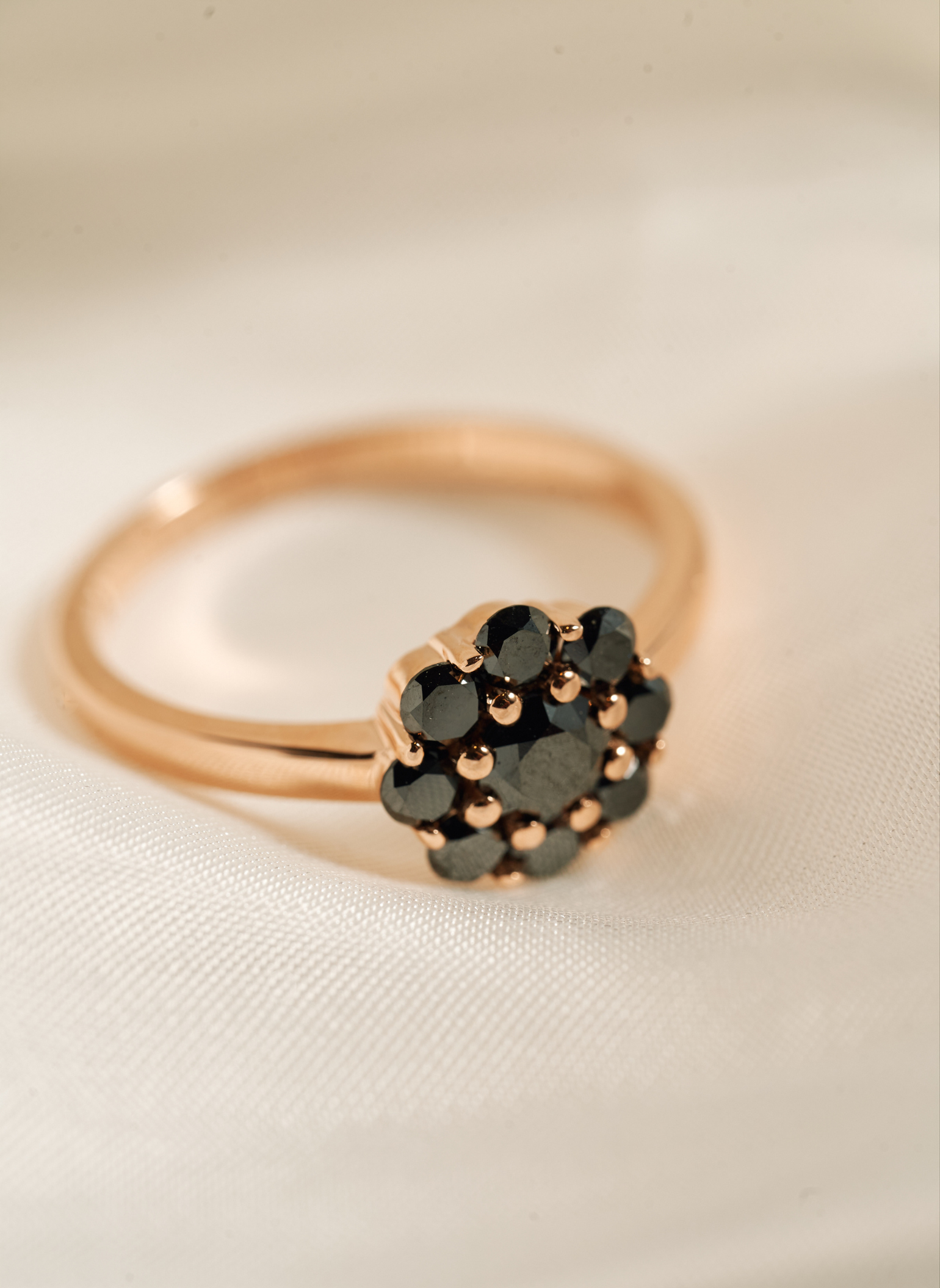 Gold rosette ring with black diamonds